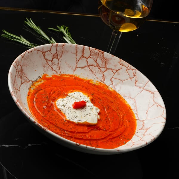 Spanish red pepper dip with white cheese and herbs, served with a glass of white wine.